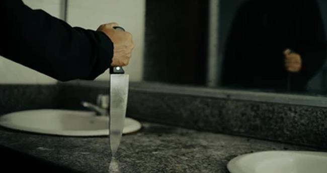a man hiding ex girl friends bathroom with a knief